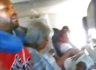 Naughty blonde shows her breasts next to strangers on the plane