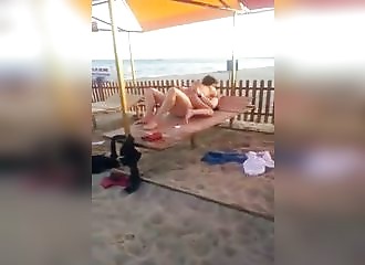 Couple caught and interrupted at the beach